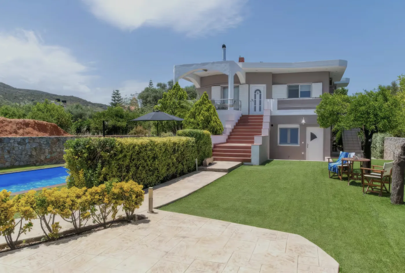 Exterior of Villa Morea with external staircase, pool and garden